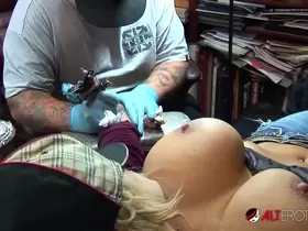 Shyla Stylez gets tattooed while playing with her tits